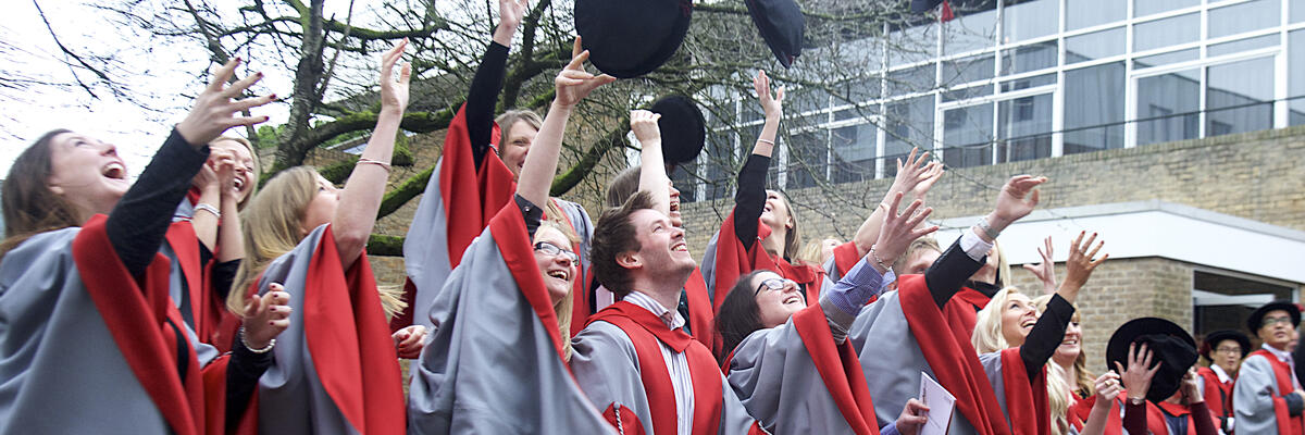 A group of graduating students throwing hats