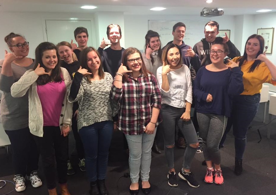 Student call team gesturing with hands to call them.