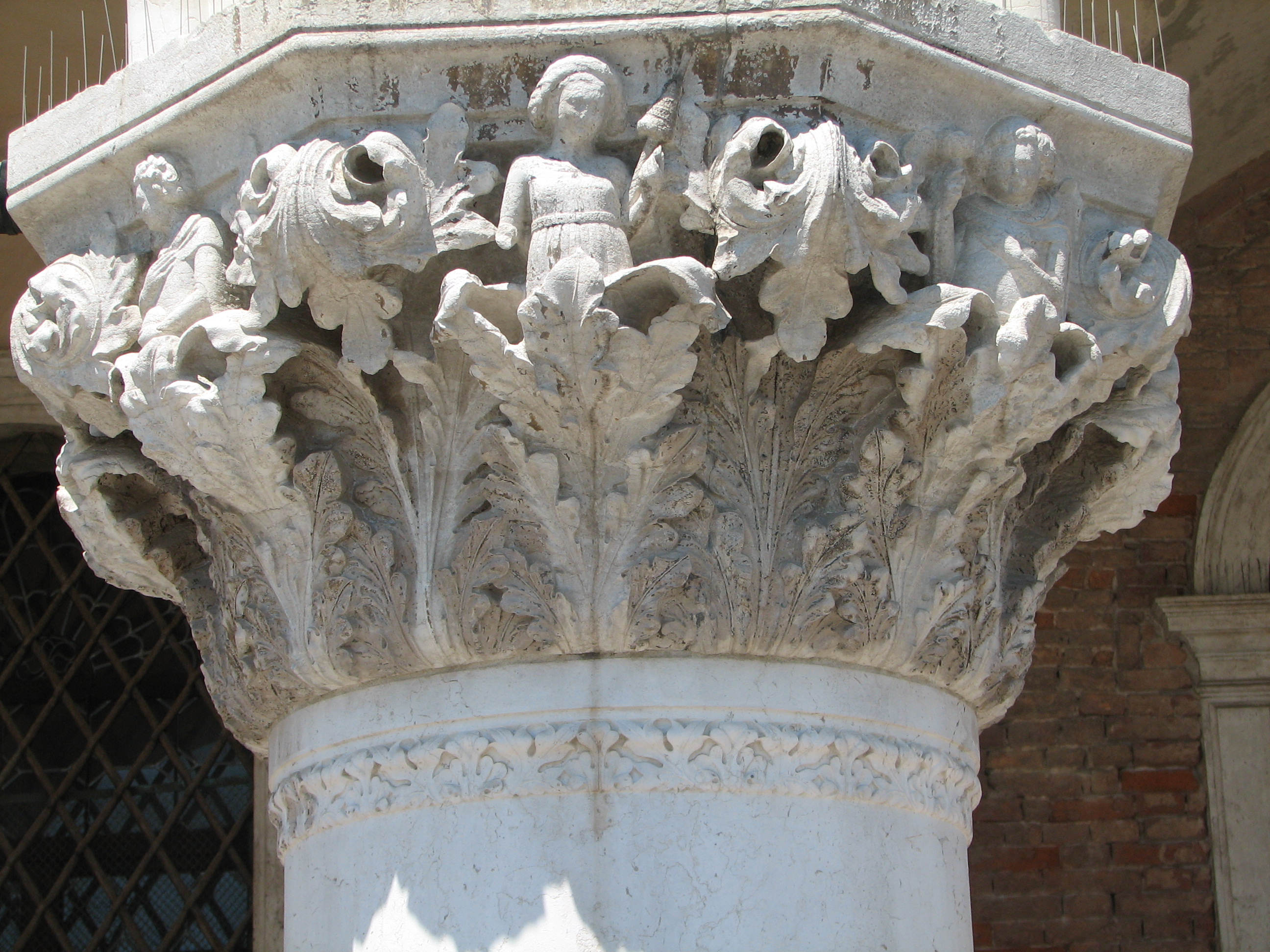 Detail of 15th capital in its current state Boy with ball, side 8, left; Woman with distaff, side 1, centre; Youth with long mantle, side 2, right