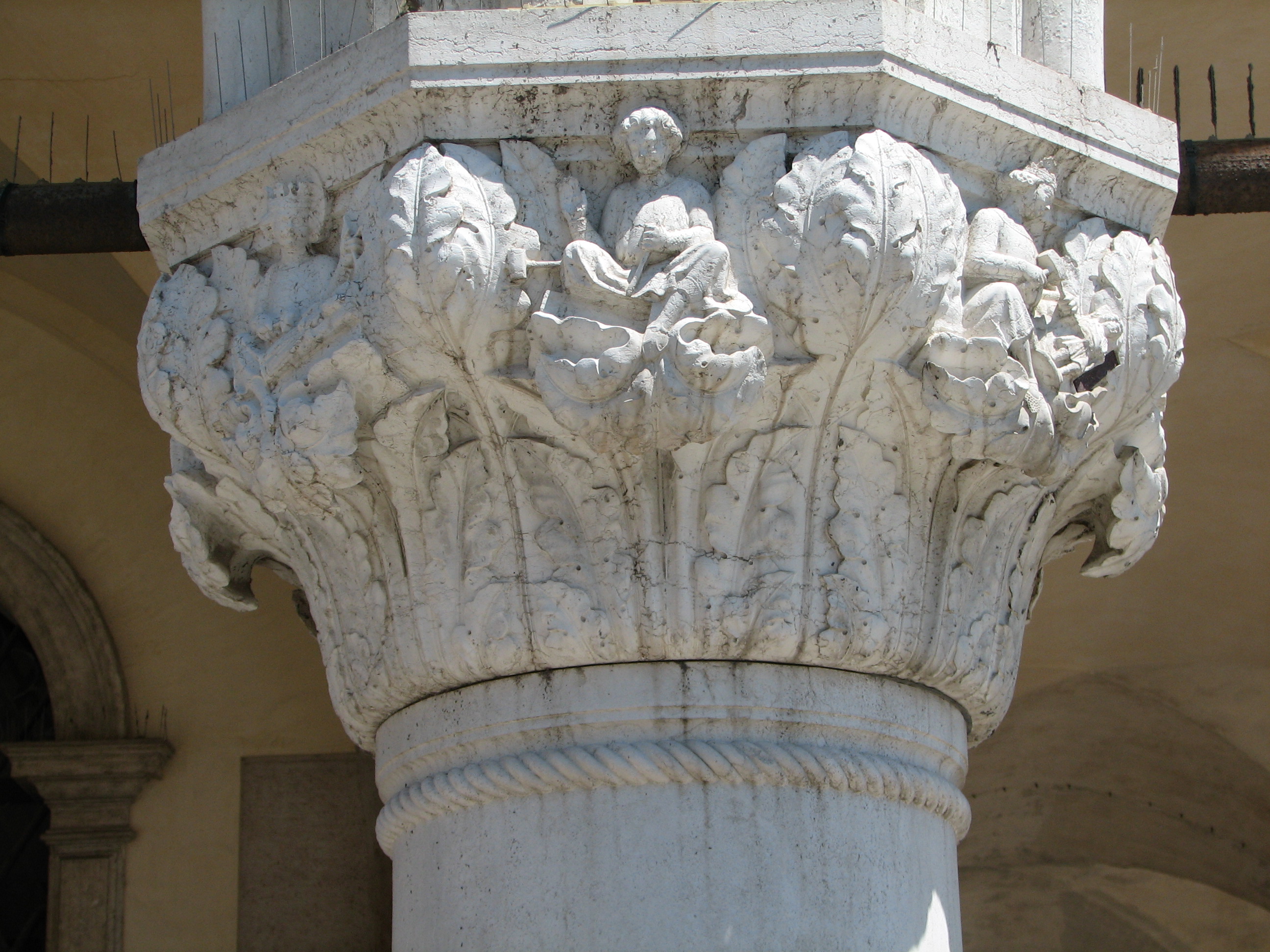 Detail of 1870s copy of 19th capital in its current state St. Symphorianus, one of the four crowned saints (St Symmachus, according to Ruskin), side 8, left; St. Simplicius, side 1, centre; St. Claudius, side 2, right