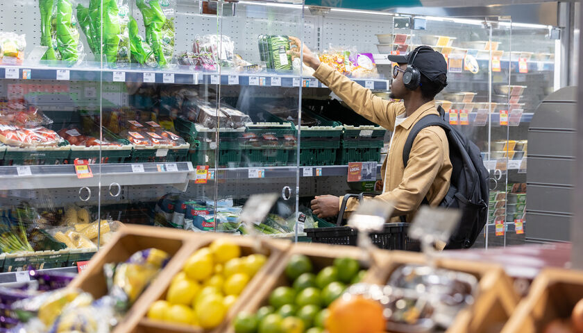 A student buying groceries in the University branch of Spar