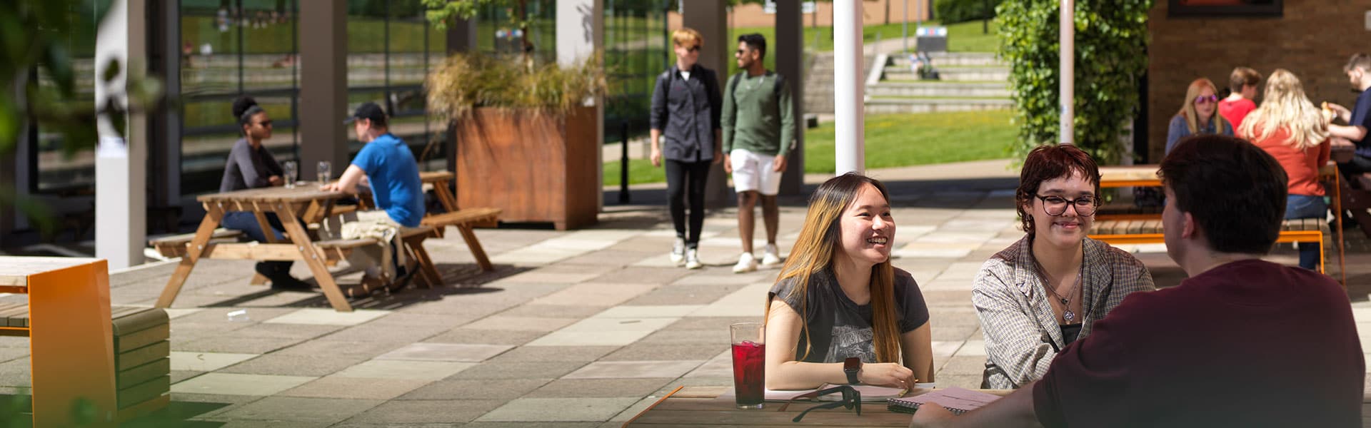 Students relaxing outdoors in a college recreation area.