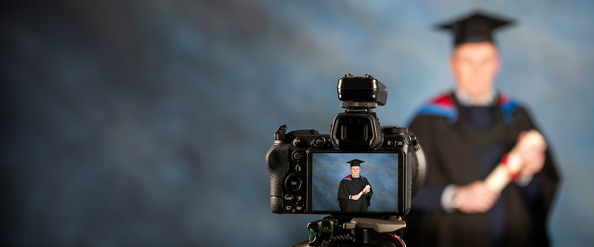 Person having photo taken with a scroll in a photography studio.