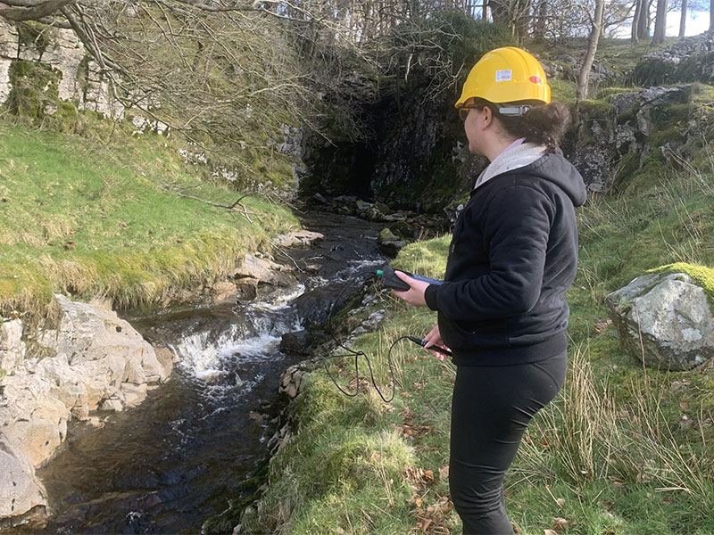 Student Lyea standing next a river.