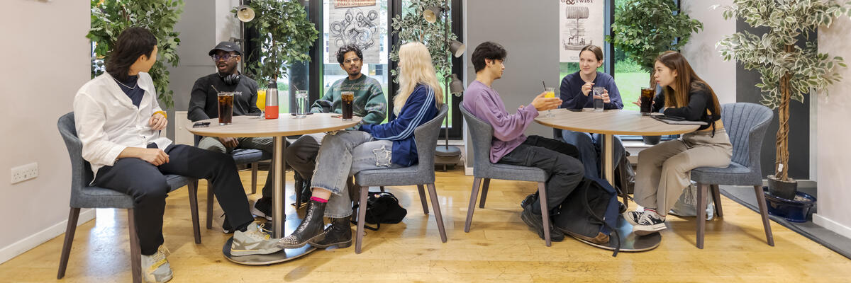 Students sat at tables socialising