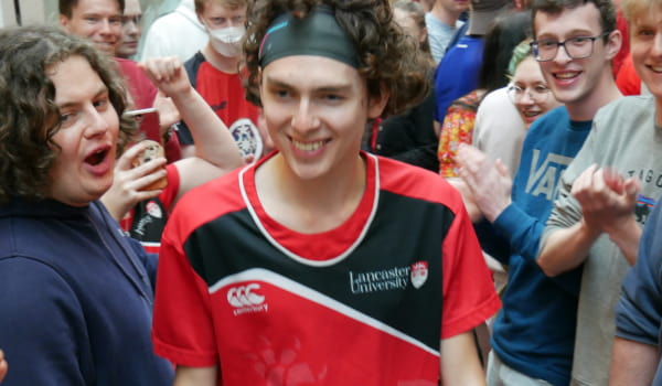 Gruffydd wearing a Lancaster University branded squash kit