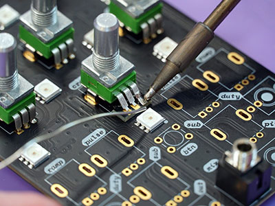 Microcomputer board being soldered