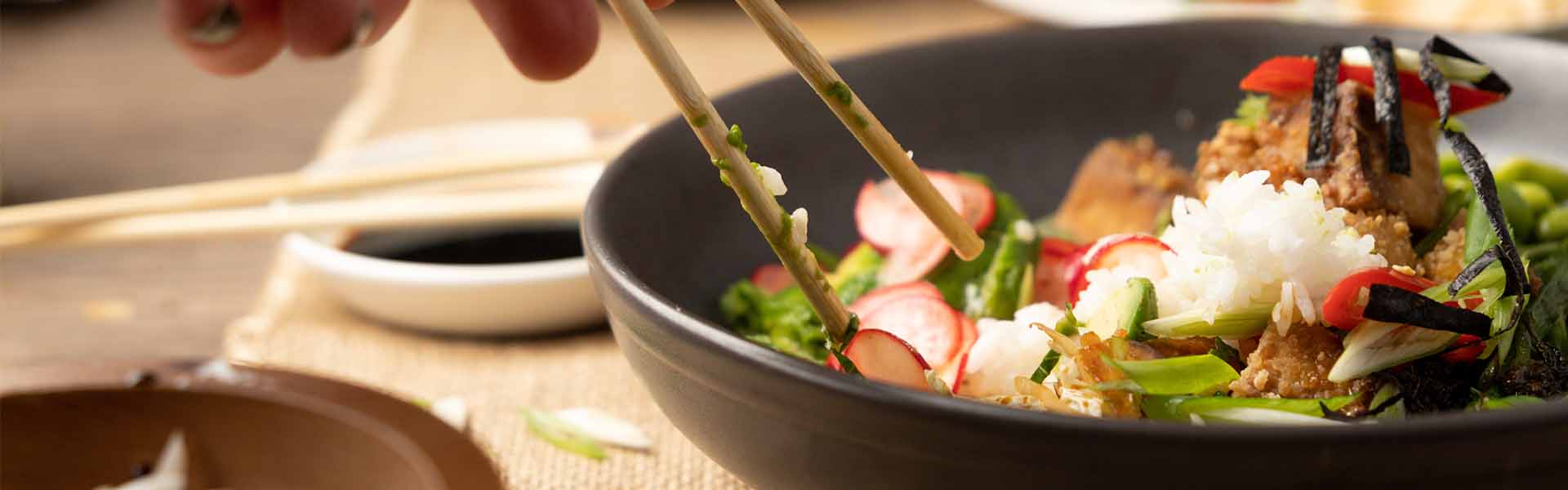 Pan-Asian meal in a dish with chopsticks