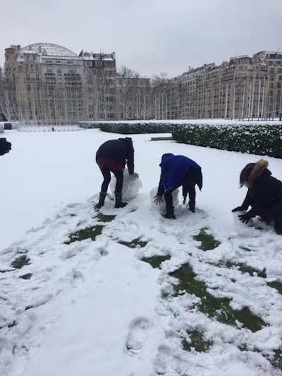 Building a snowman with team mates