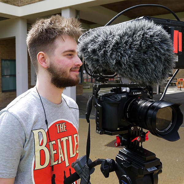 Digital Content Ambassador James next to film camera and boom