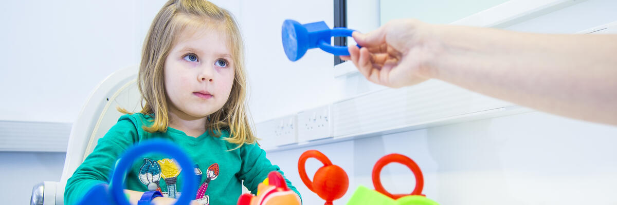 A young girl playing with toys in the BabyLab