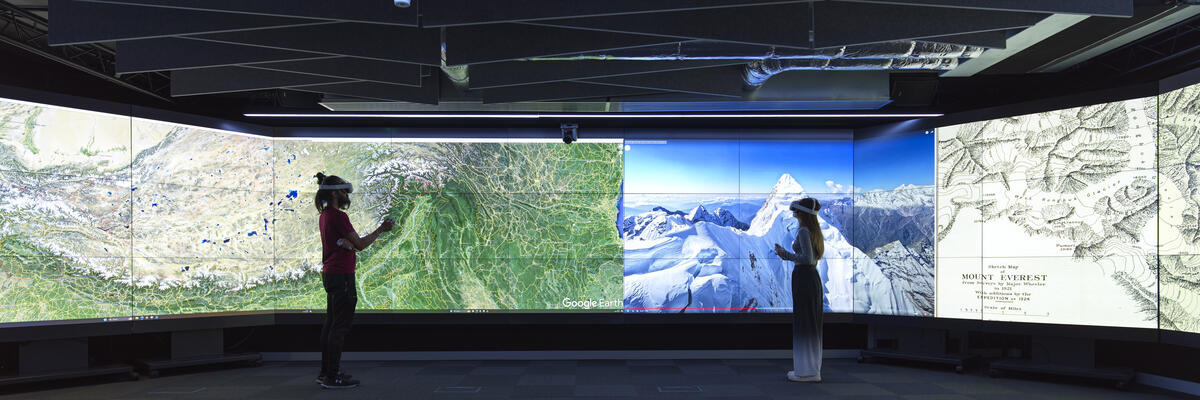 Two individuals wearing VR headsets in the Data Immersion Suite