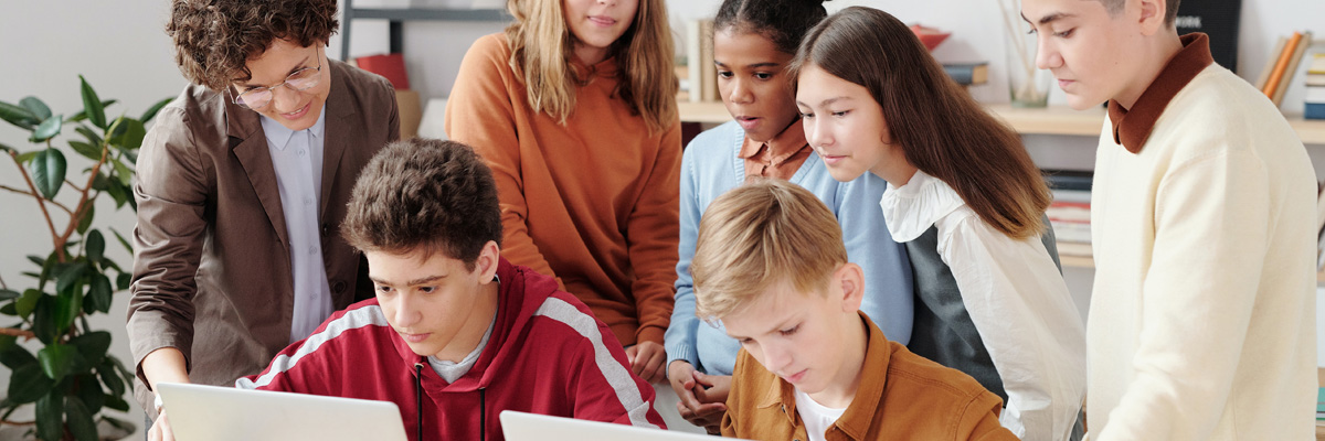 School children sat around laptops