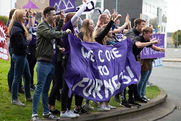 Furness students holding welcome banners