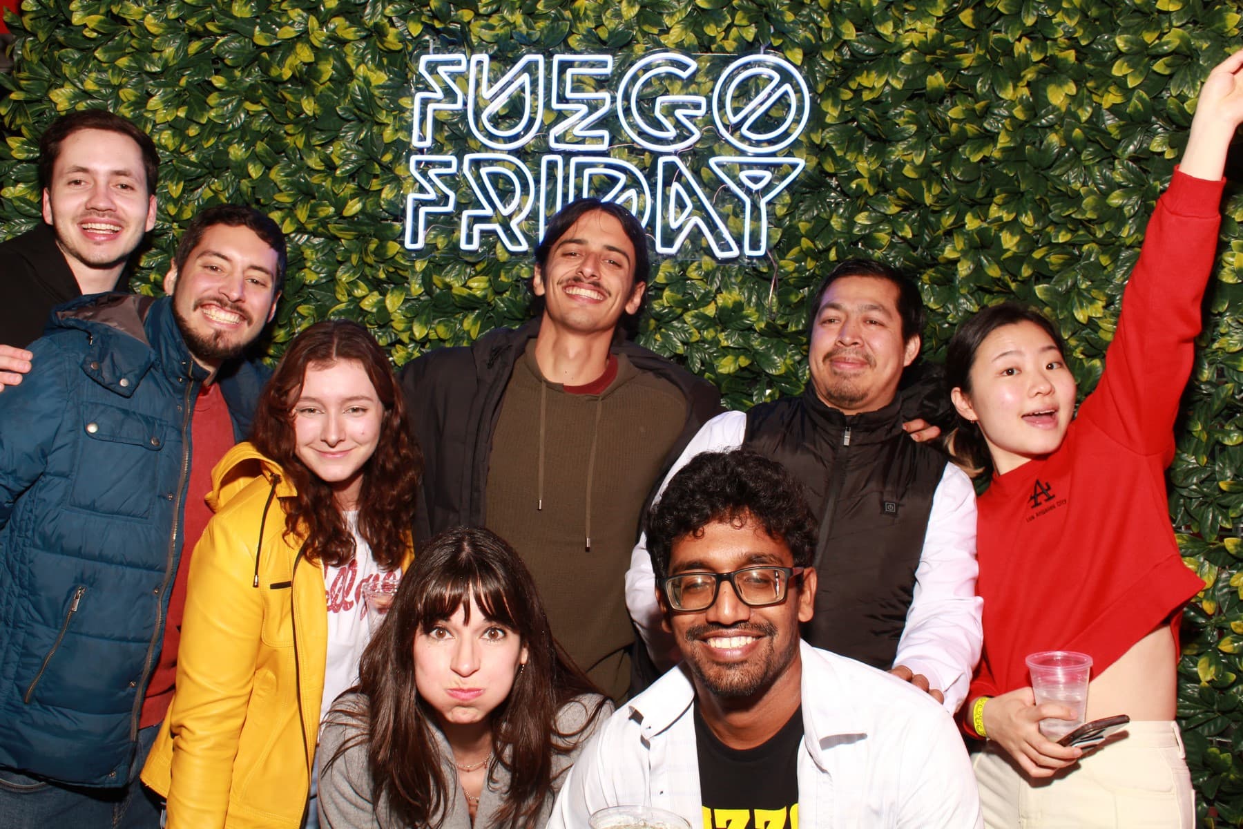 Group of students smiling and pulling faces under a "Fuego Fridays" sign in Missouri, USA