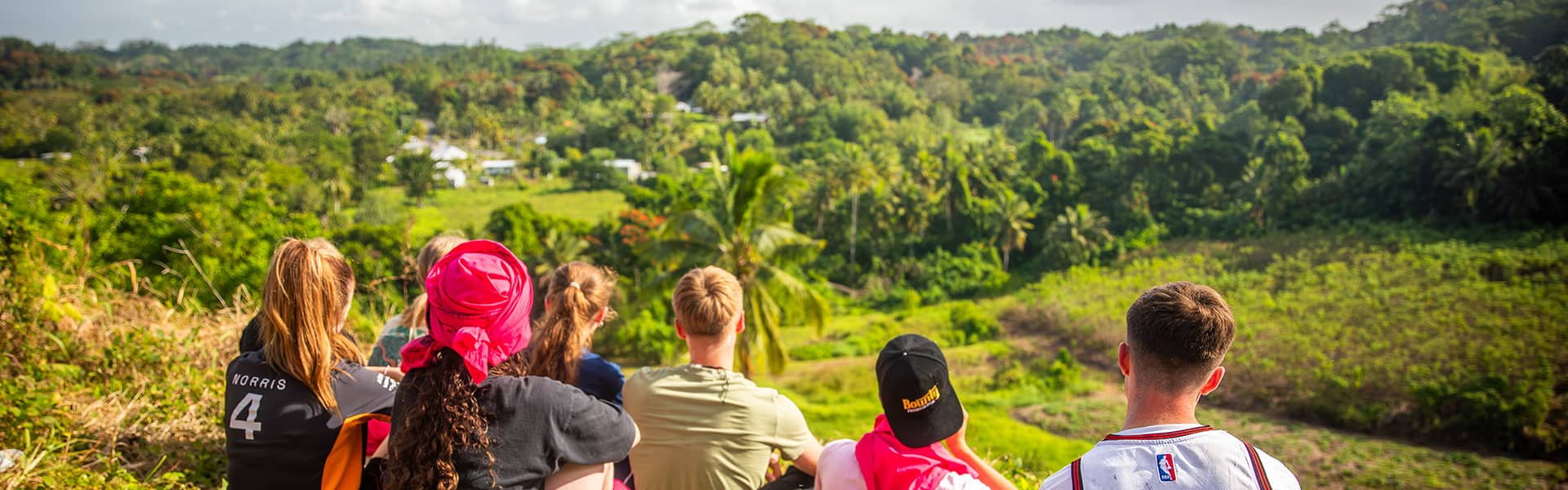 Group of students sat looking out over a viewing point in Fiji