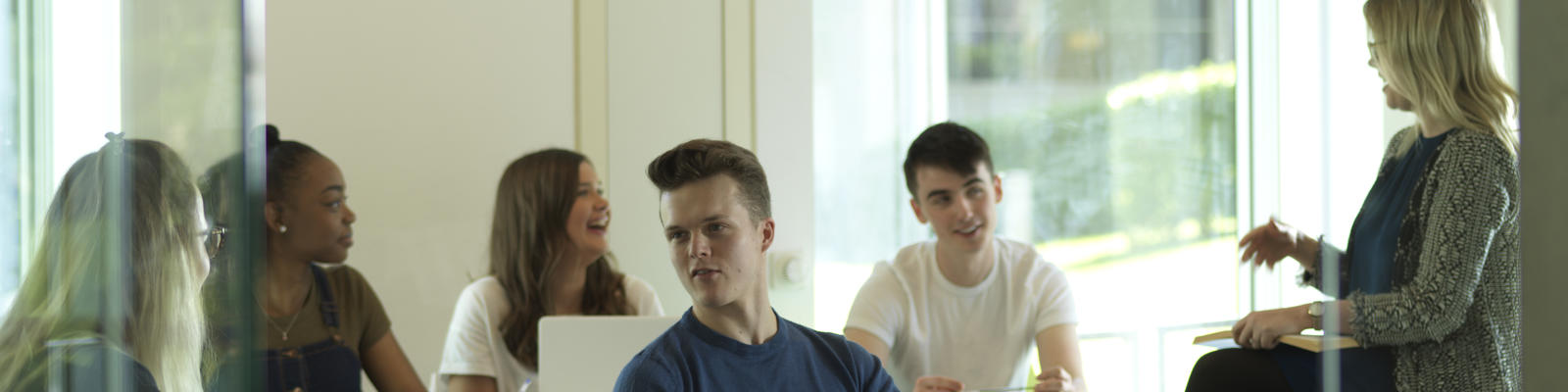 Lecturer talking to a small group.