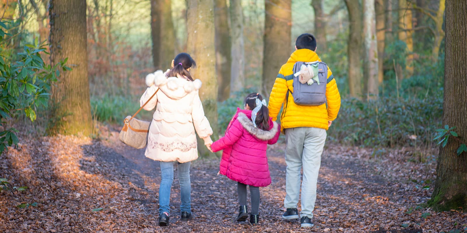 Lancaster University family taking a walk through the woodlands within the grounds.