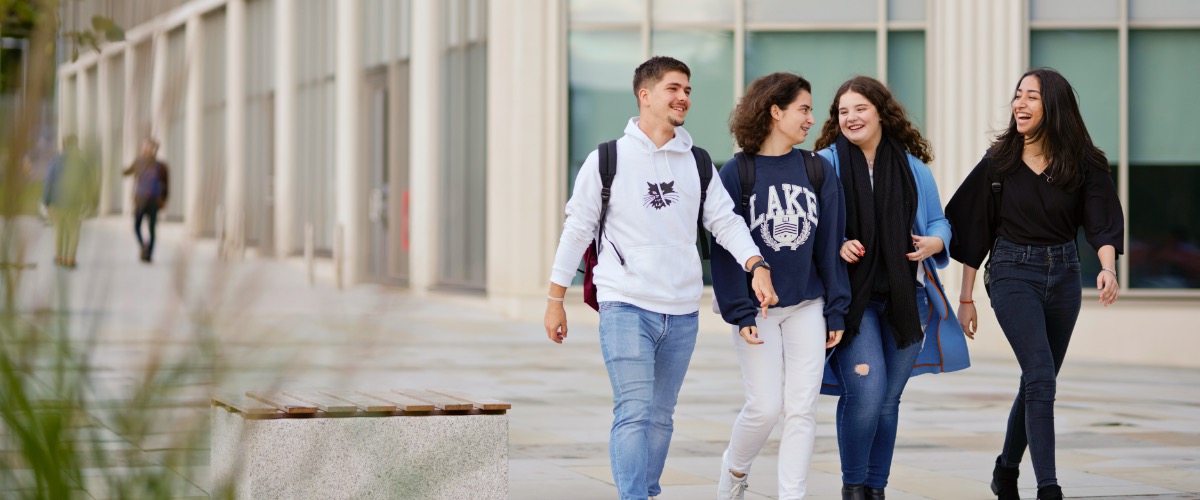 Students walking around campus near the Management School