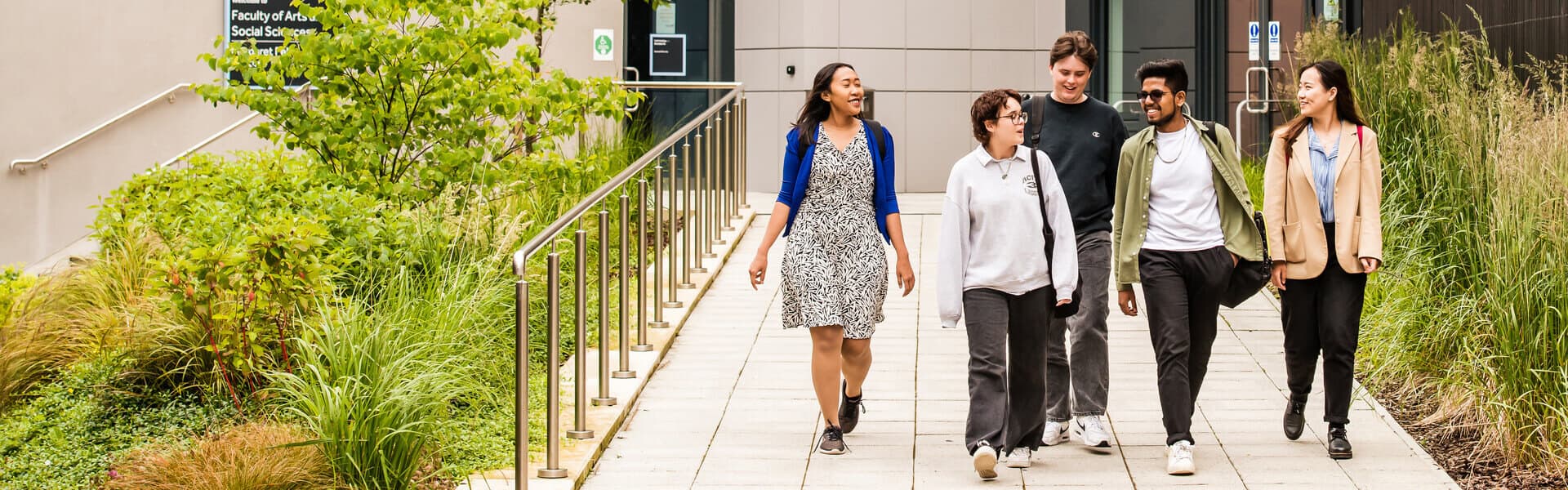 A group of students walking outside a lecture theatre