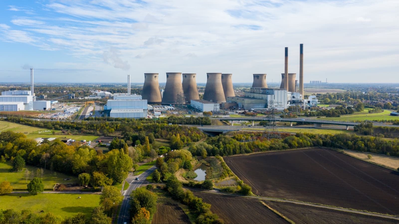 An aerial view of the Ferrybridge power station in Yorkshire. Another power station's cooling towers are on the horizon.