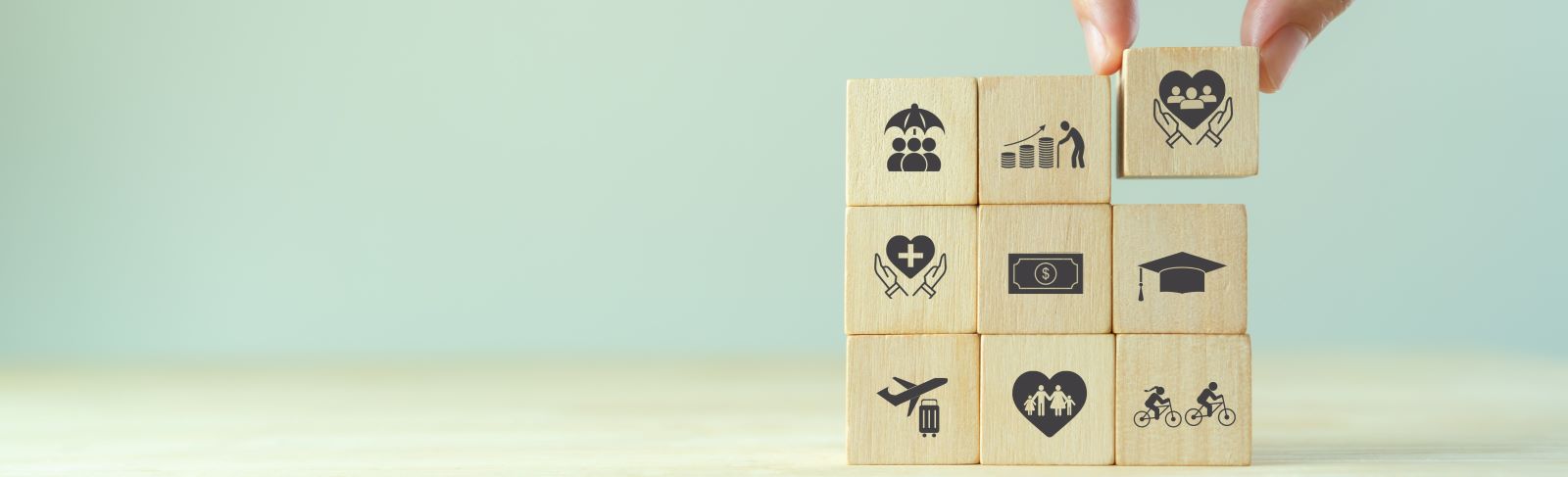 Wooden Blocks stacked into a cube shape each with an icon on the front.