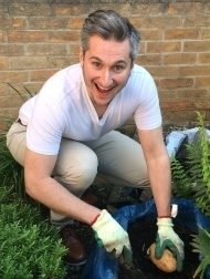 Image of Dr Dmitry Yumashev planting potatoes