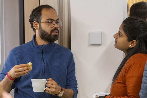 Two researchers chatting over coffee 