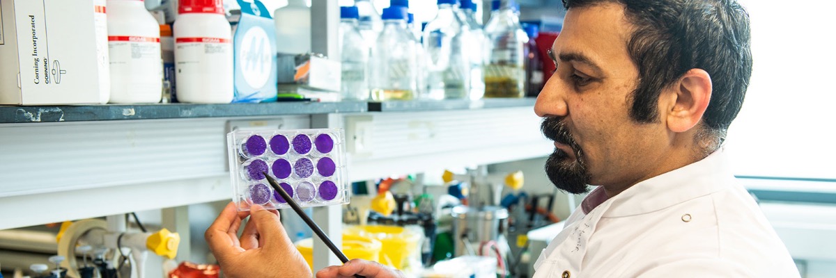 Professor Muhammad Munir takes samples in a laboratory.