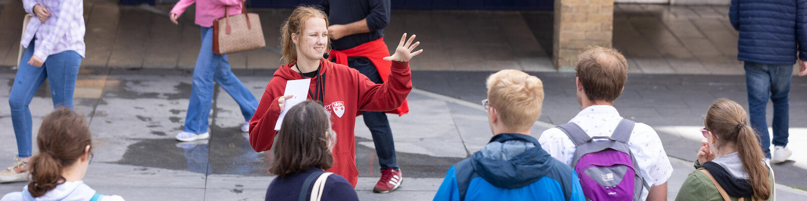 Ambassador giving tour to group of students in central square