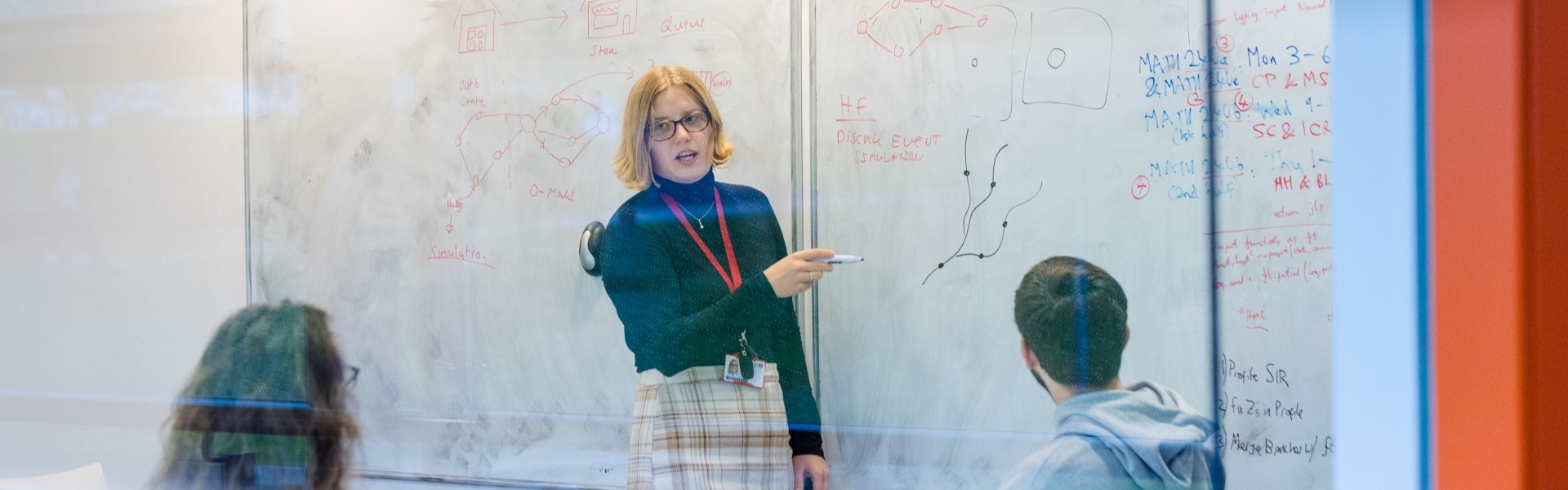 Student pointing at whiteboard