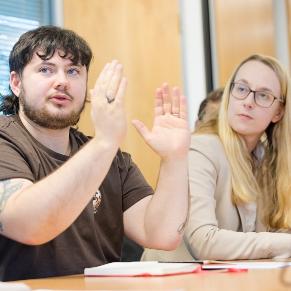 Student speaking at a group meeting