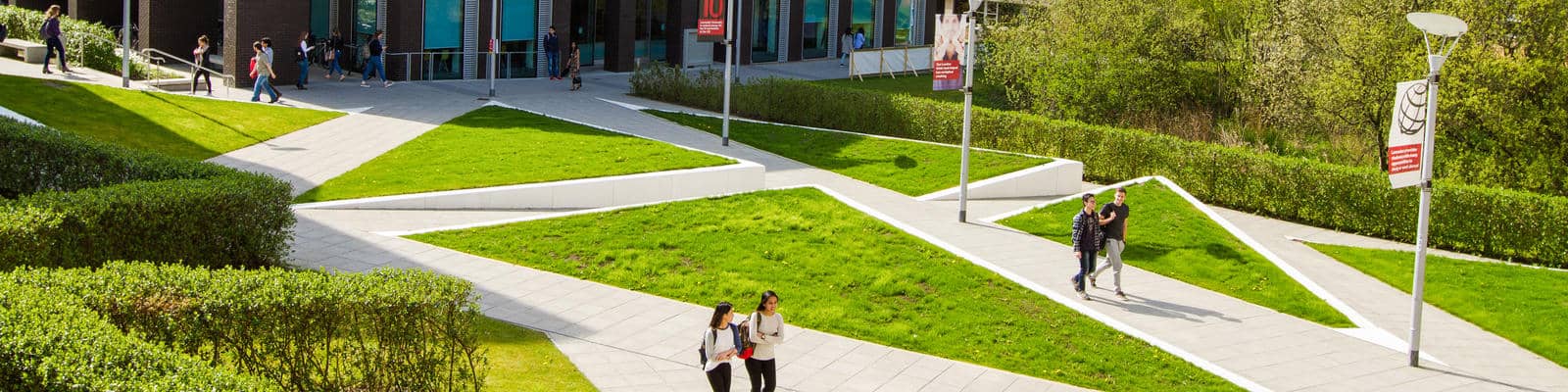 Wide angle image of students walking around campus