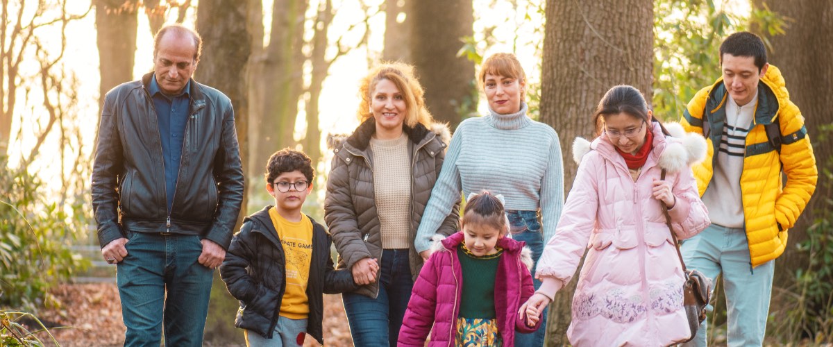 Families walk in the woods on campus