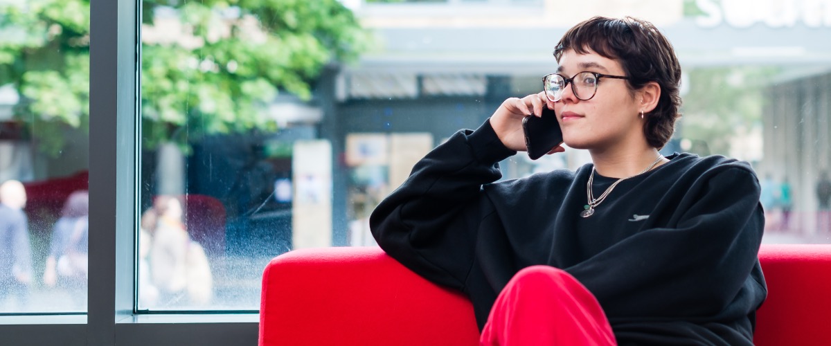 A student in the learning zone talks on the telephone.