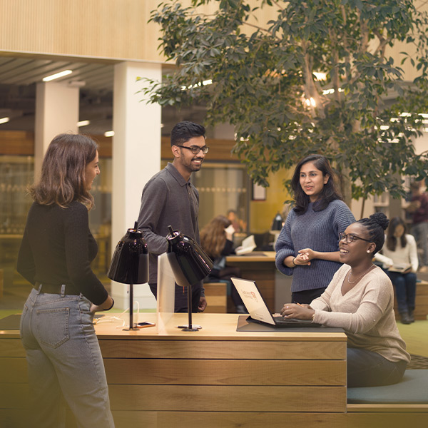 A group of students share a joke in the Library