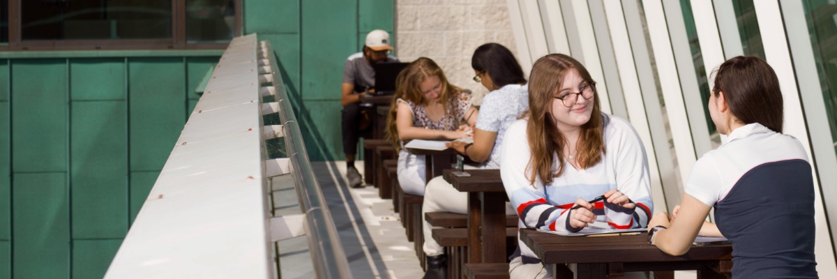 Students dining on the Infolab roof terrace.