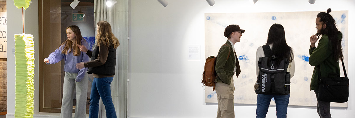 Students discuss an exhibit in an art gallery