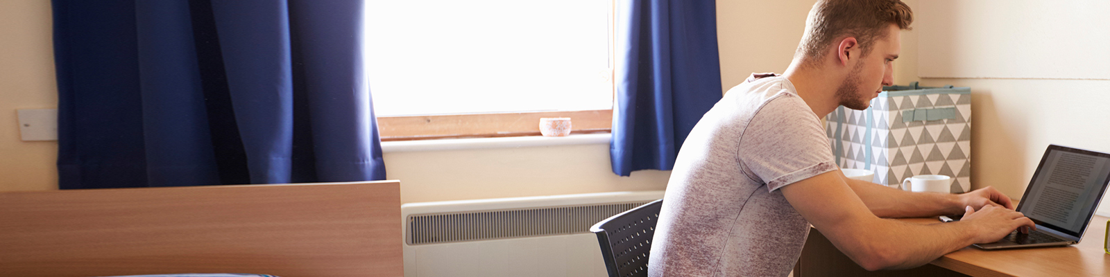 Student in their room on campus.